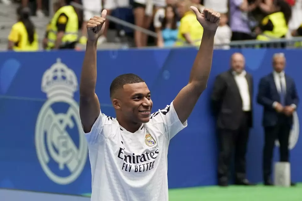 Kylian Mbappe mengacungkan jempol saat diperkenalkan kepada penggemar Real Madrid di stadion Santiago Bernabeu di Madrid, Selasa, 16 Juli 2024. 